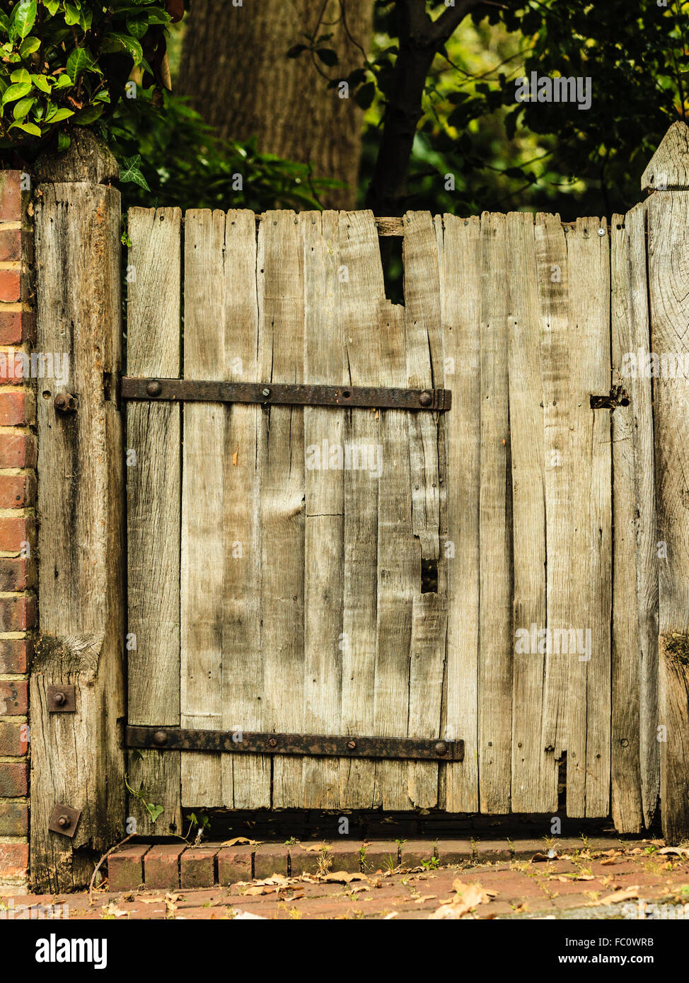 Rustic old wooden gate in brick wall Stock Photo Alamy