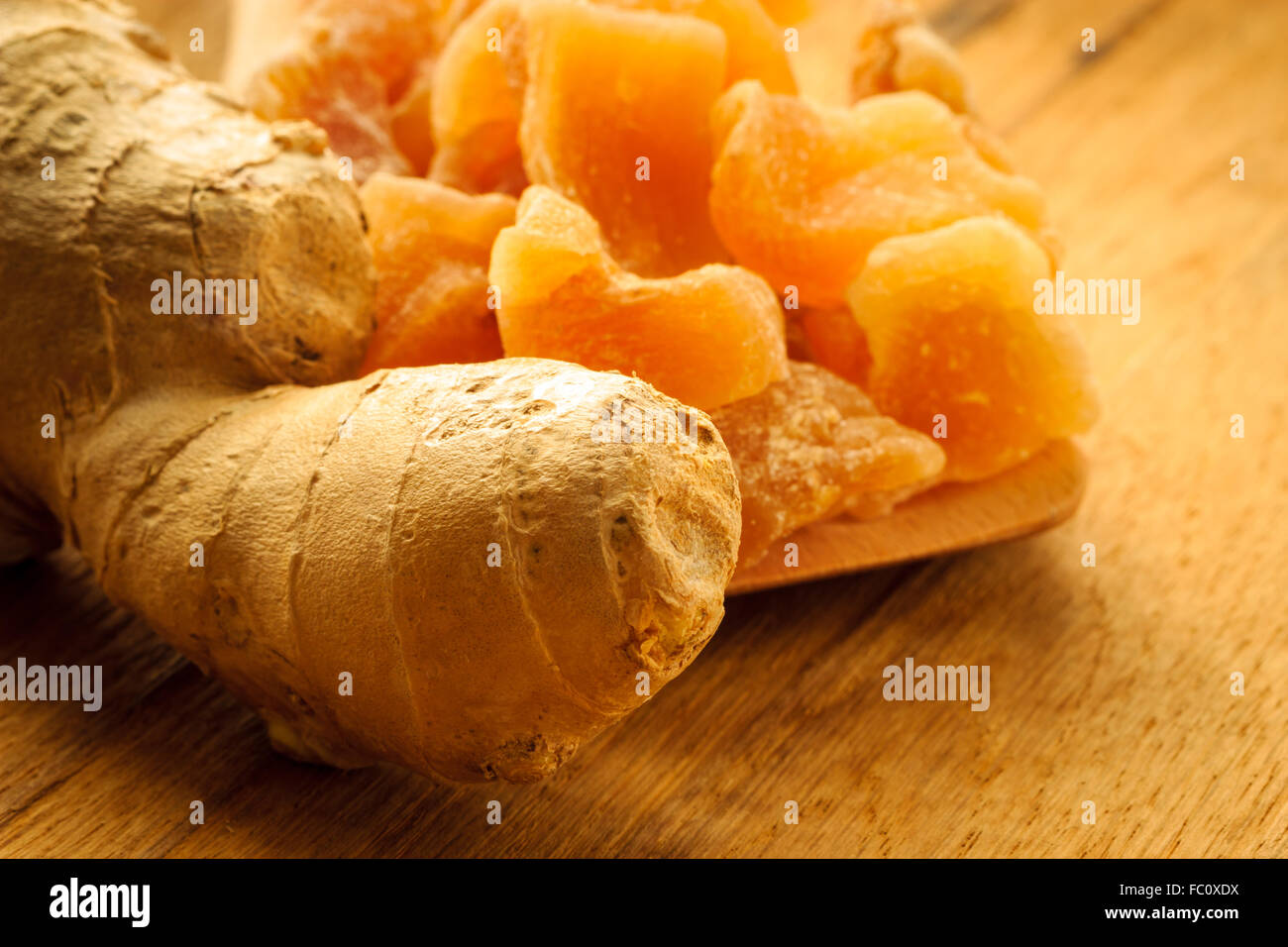 Closeup root and candied ginger on wooden table Stock Photo