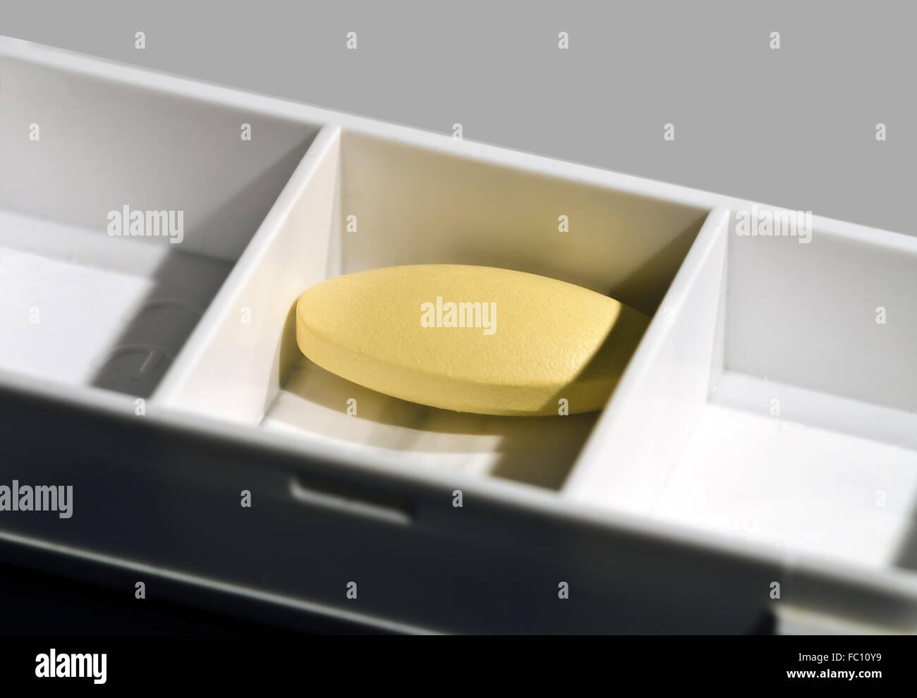 medicin box with yellow tablet Stock Photo