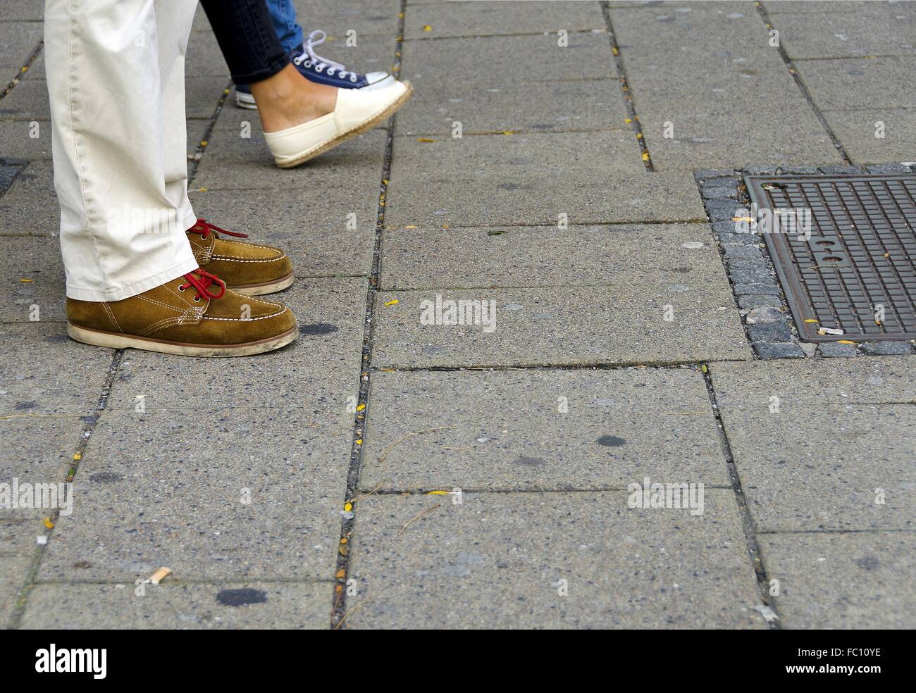 feet of shoppers on a paved sidewalk Stock Photo