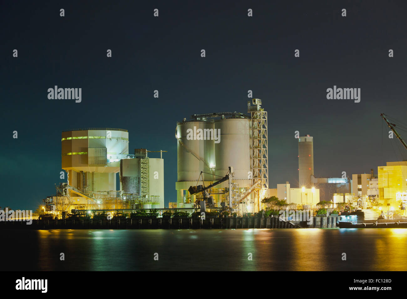 Oil tanks at night in gas factory Stock Photo