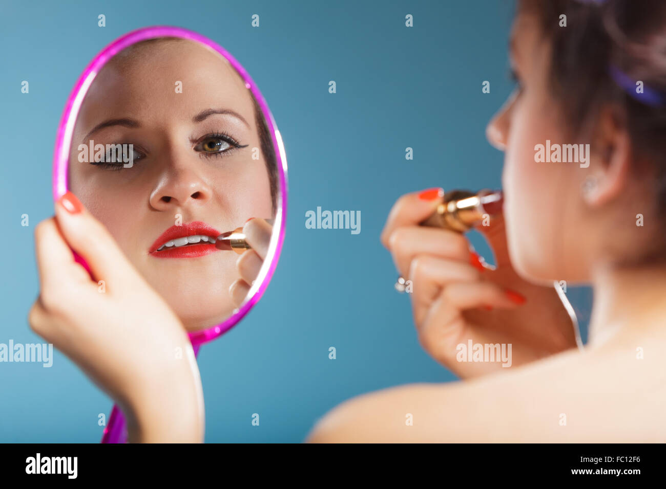 Woman applying red lipstick Stock Photo Alamy