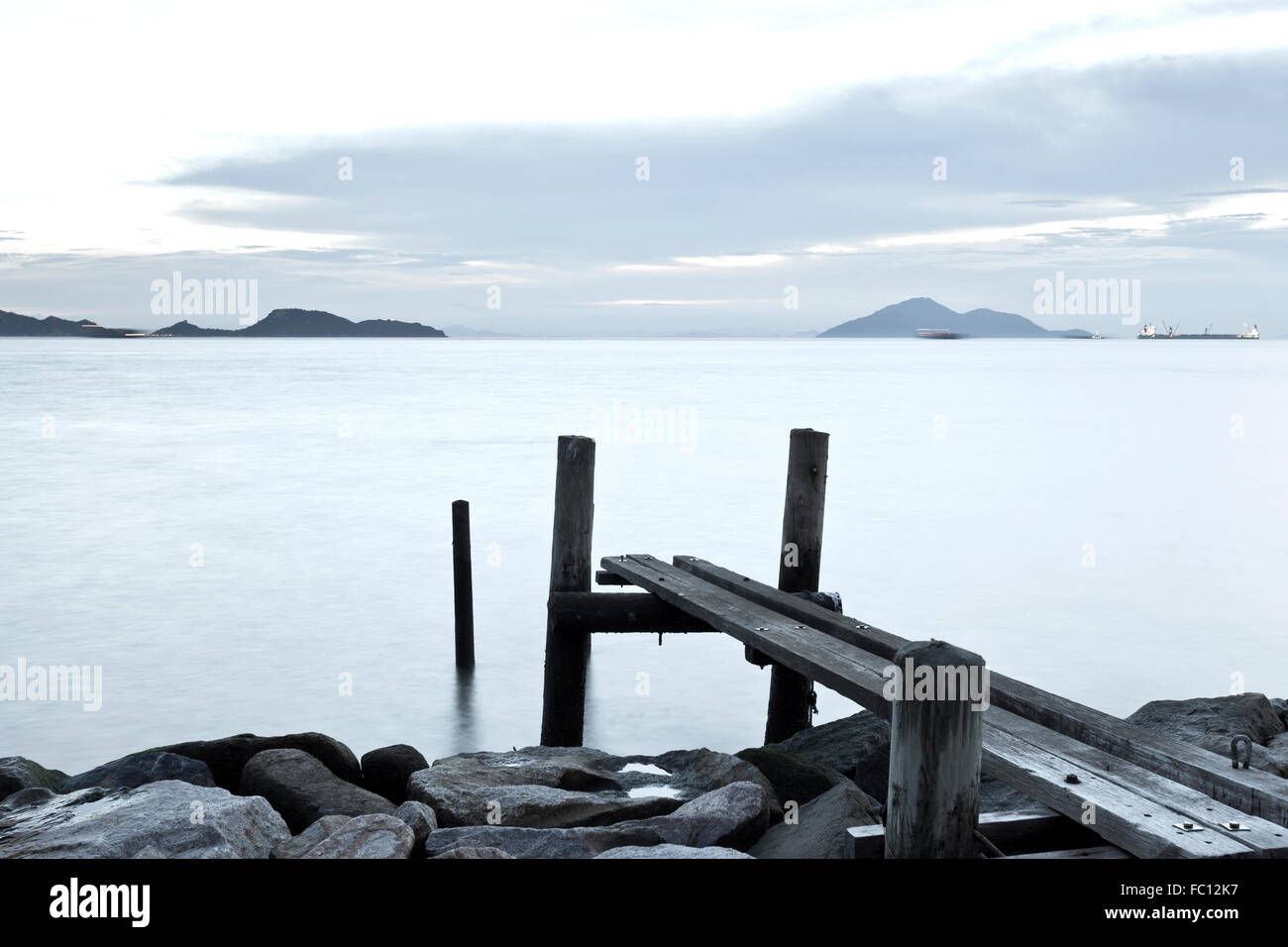 Clam sunset with jetty on sea Stock Photo