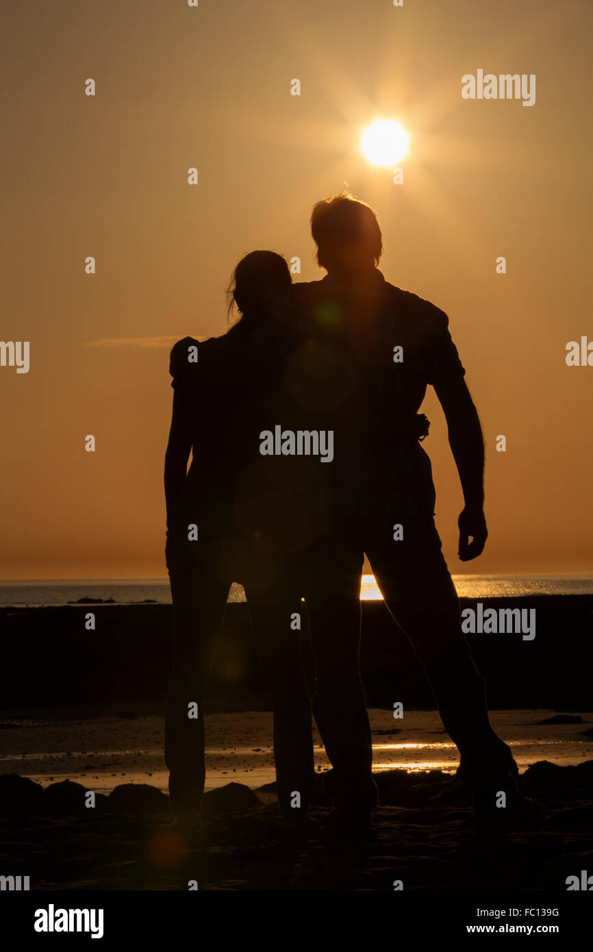 Two in the sundown embrace Stock Photo