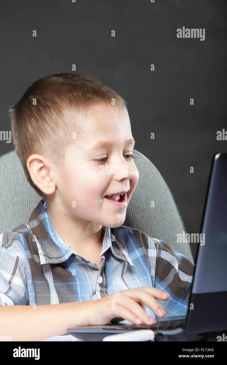 Computer addiction child with laptop notebook Stock Photo