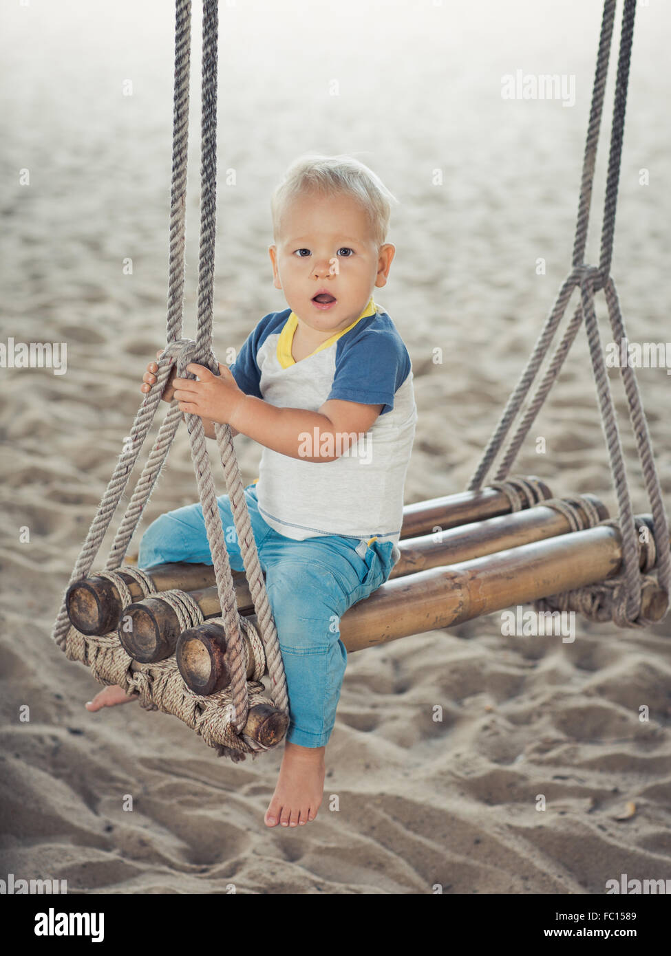 Baby on a swing Stock Photo Alamy