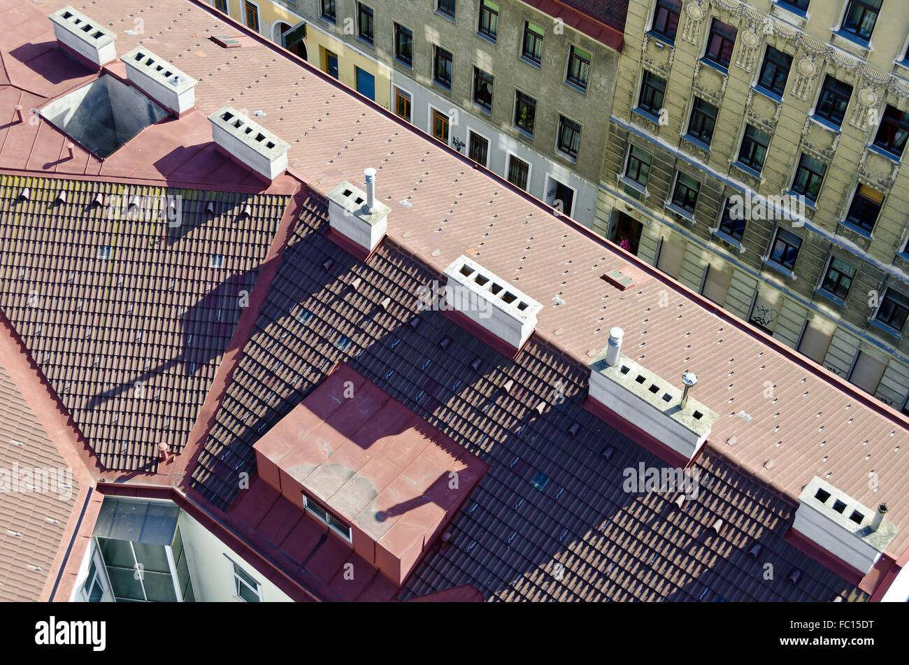 red tiled roof with many white chimneys Stock Photo