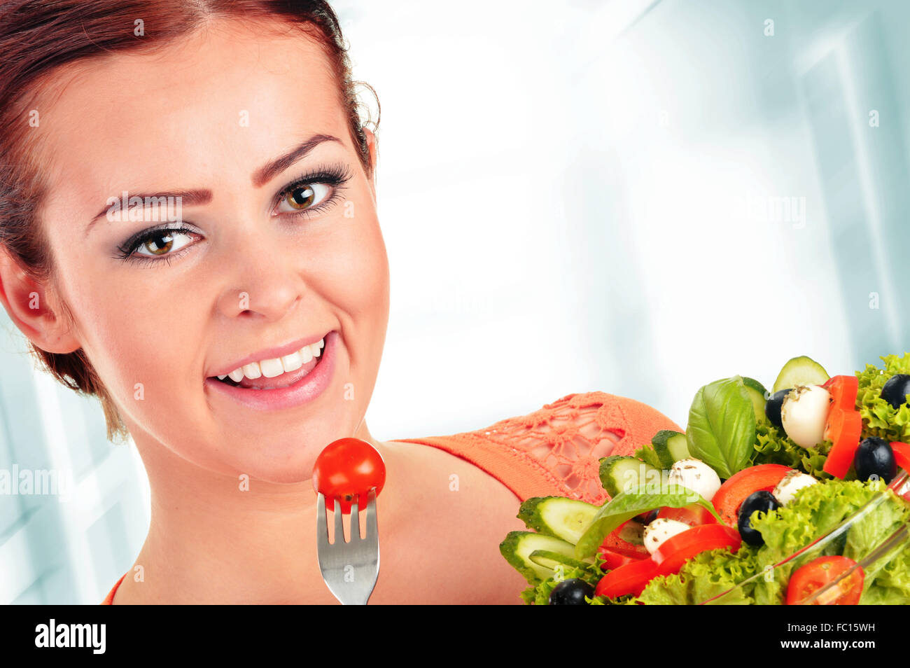 Young woman eating vegetable salad Stock Photo