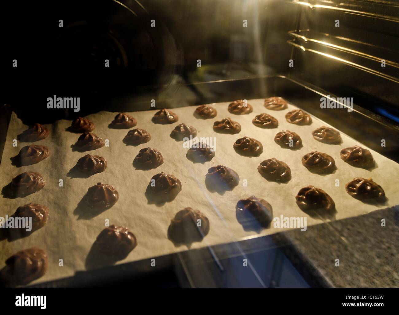 chocolate spritz biscuits in a baking oven Stock Photo