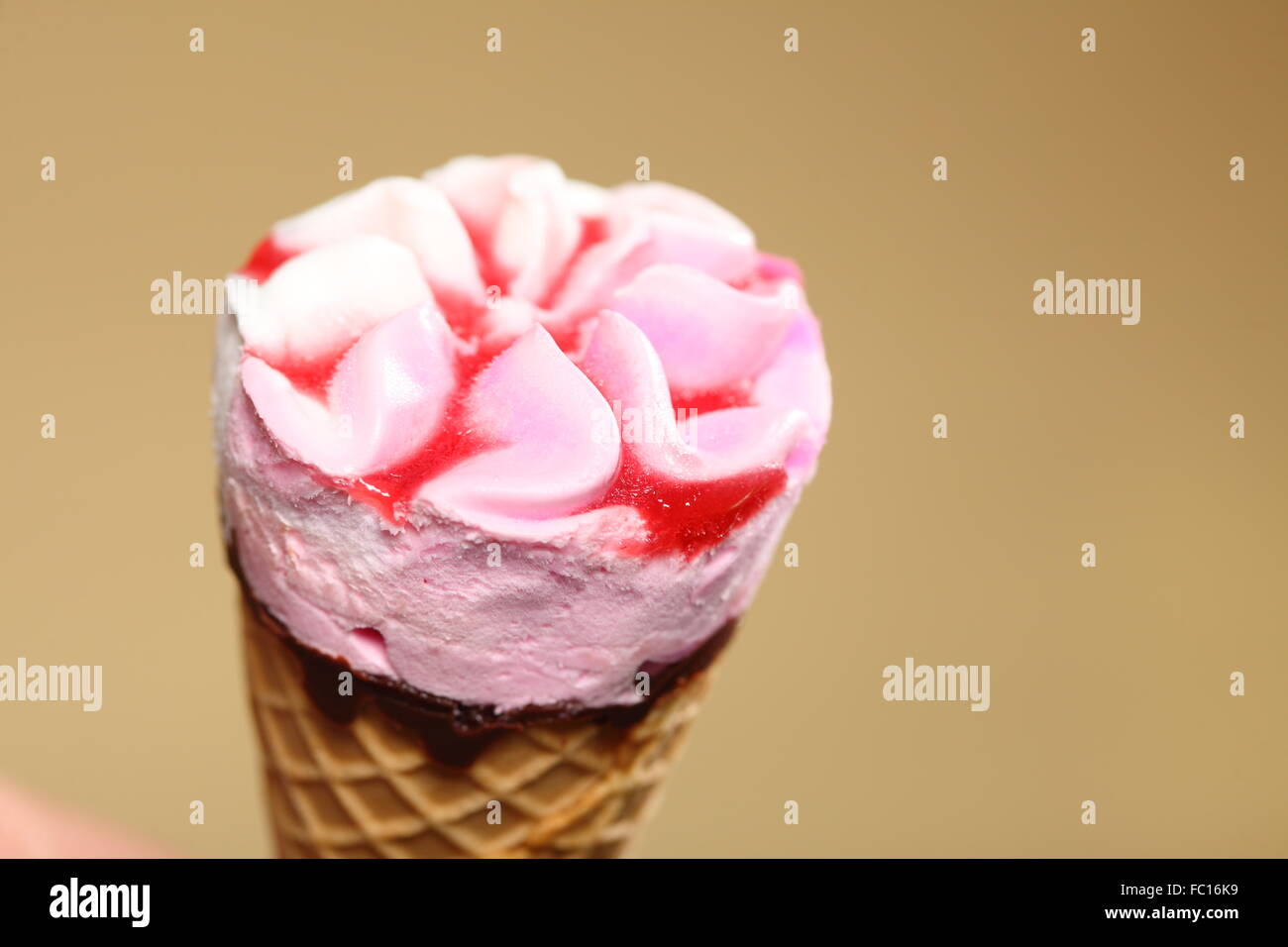 Berry icecream waffle cone on brown Stock Photo
