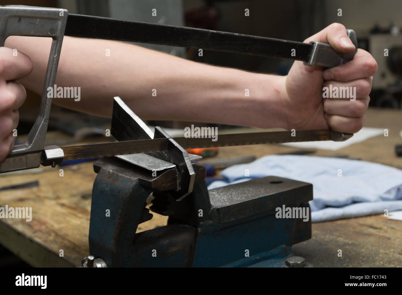 Person working with hacksaw Stock Photo