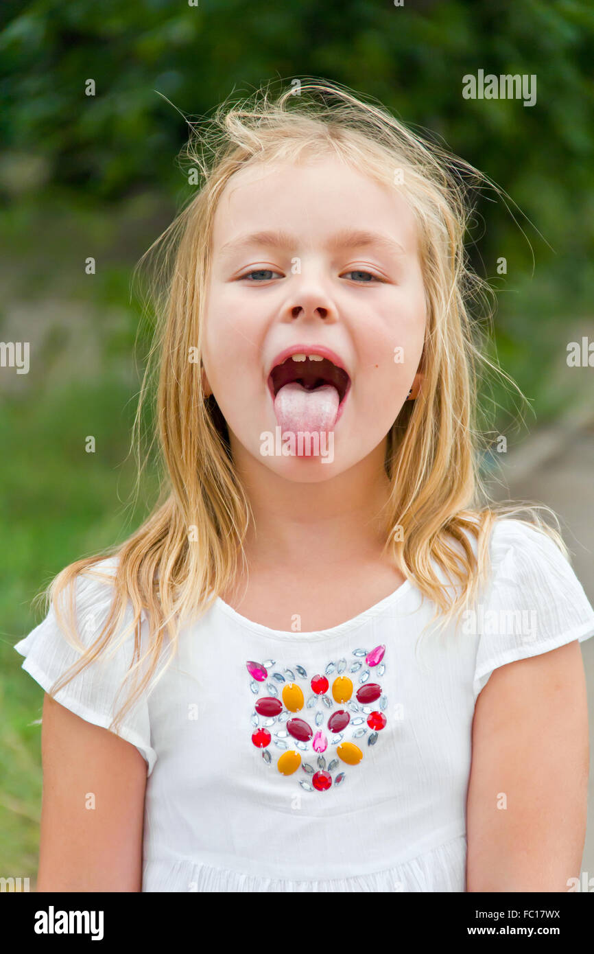 Cute girl with put out tongue Stock Photo