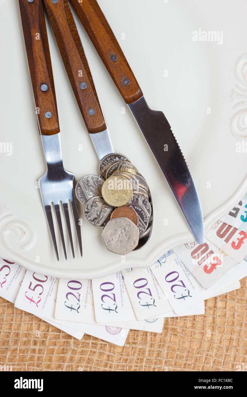 British money on kitchen table, coast of living Stock Photo