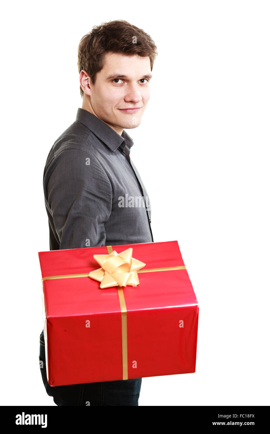 Holiday. Man giving red gift box with golden ribbon Stock Photo Alamy