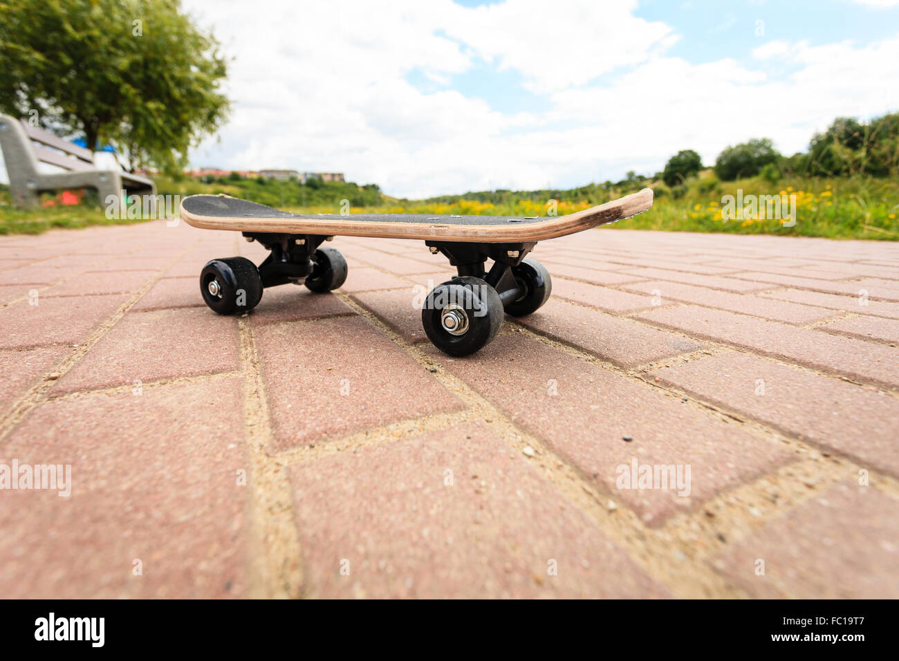 lone skateboard deck outdoor on paving stone Stock Photo Alamy