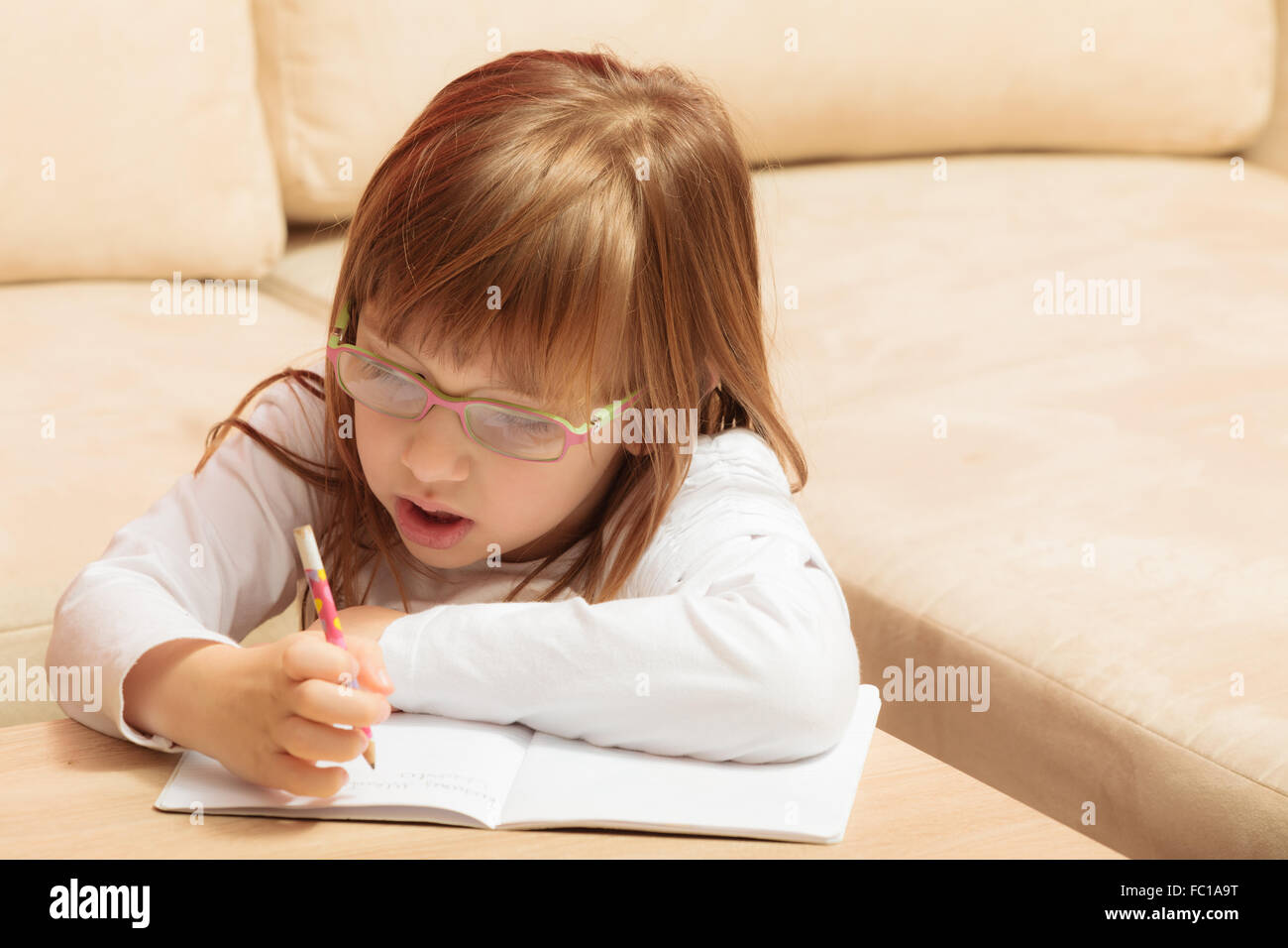 little girl writing in her notebook Stock Photo Alamy