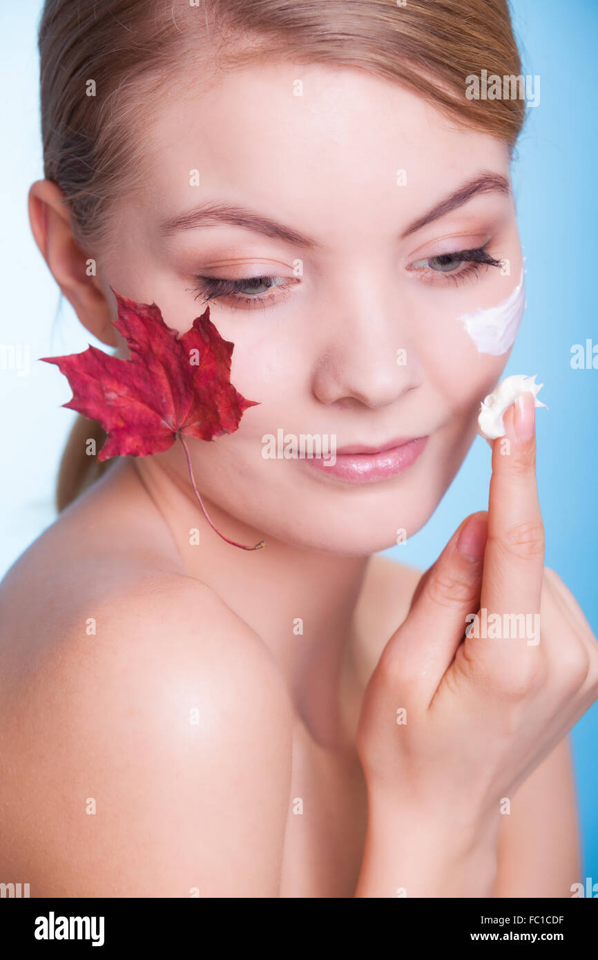 Skin care. Face of young woman girl with red maple leaf Stock Photo Alamy