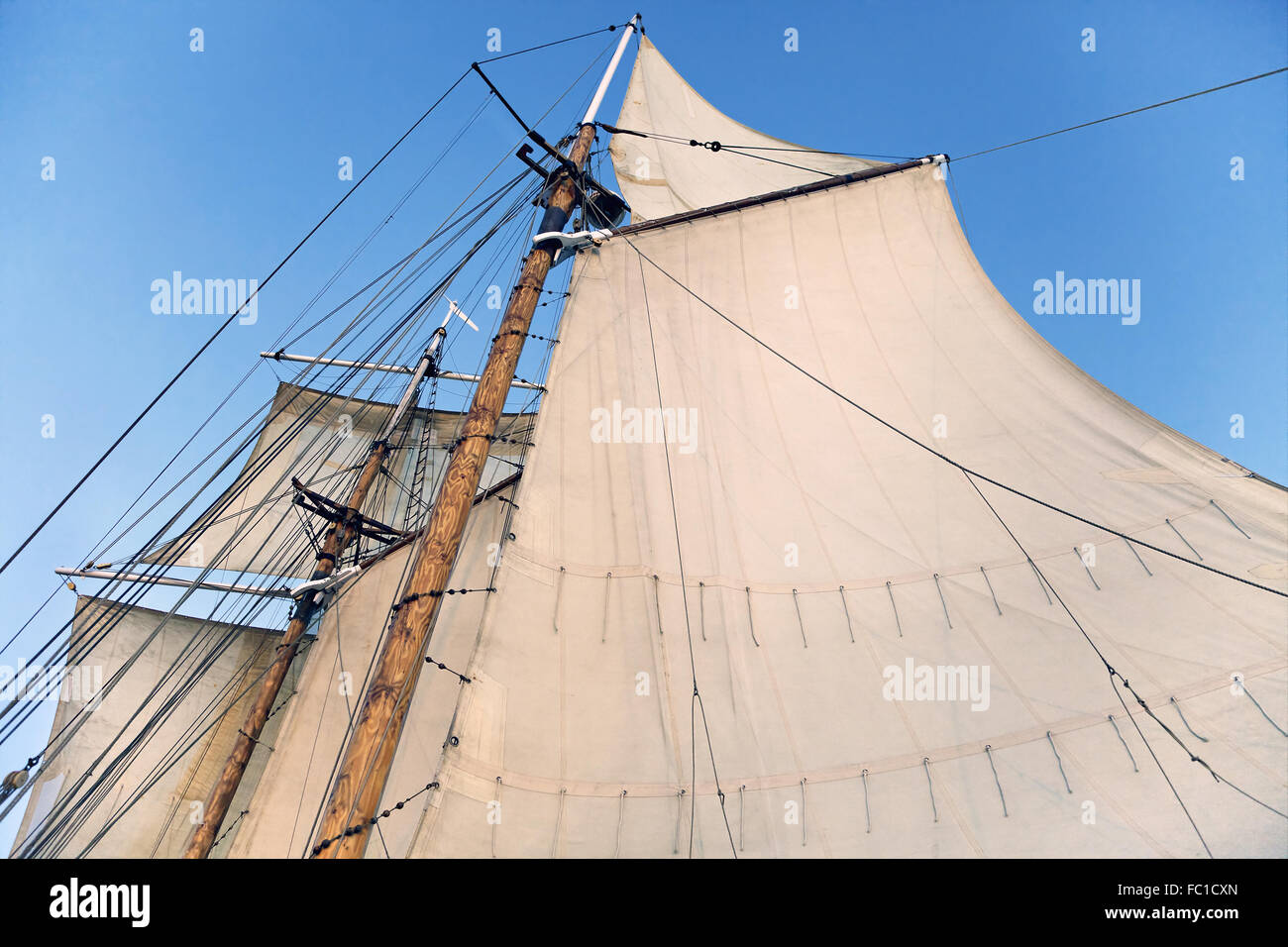 Mast of a tall ship with half-hoisted sails Stock Photo - Alamy
