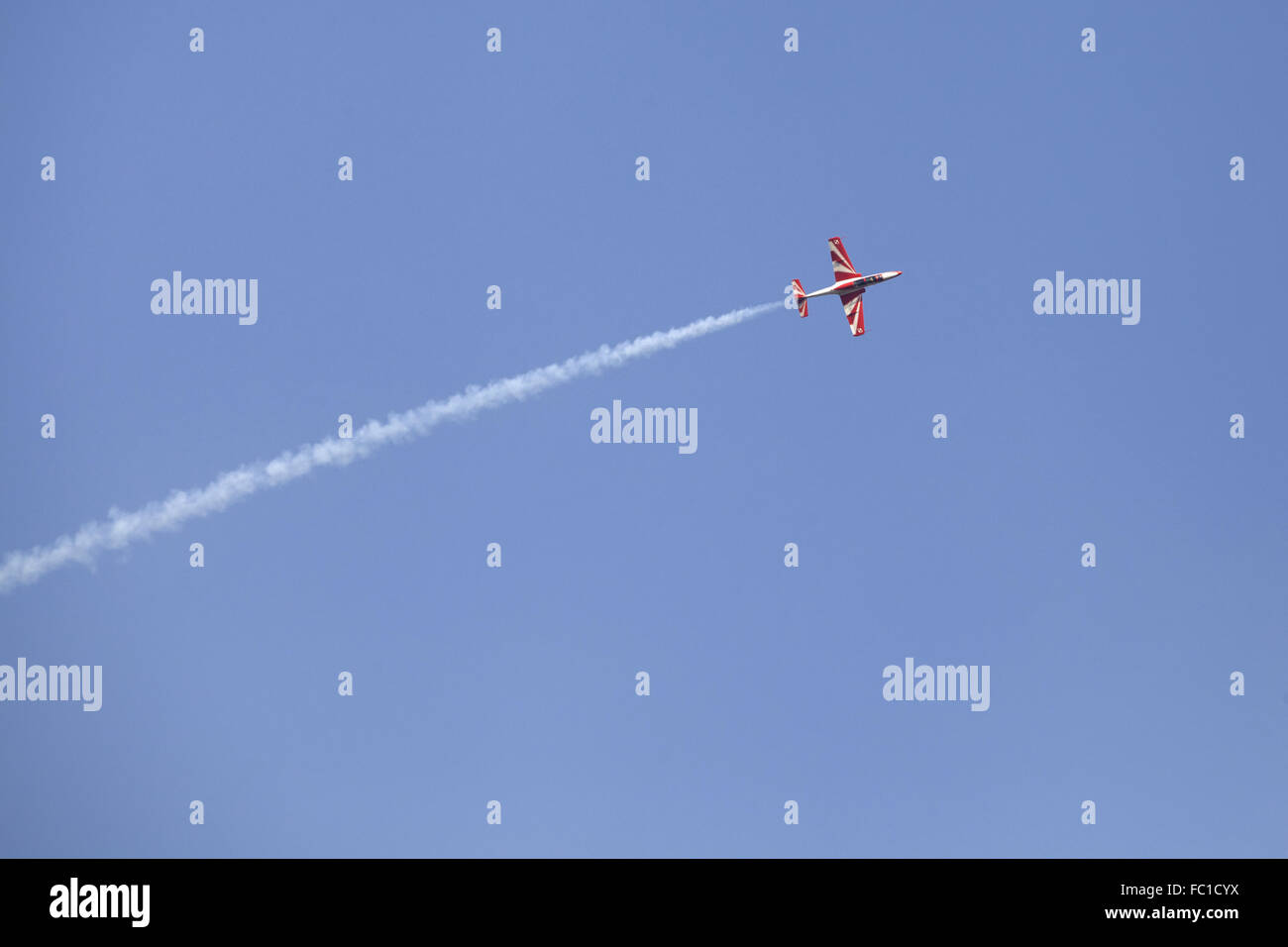 Plane on an air show against blue sky Stock Photo - Alamy