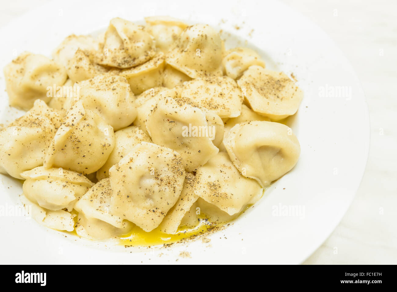 cooked pelmeni sprinkle with pepper Stock Photo