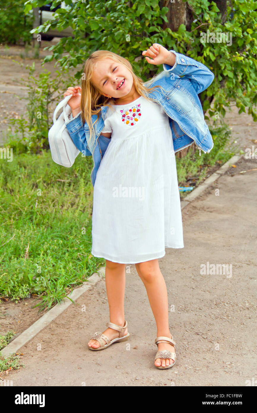 Cute girl playing with white bag Stock Photo