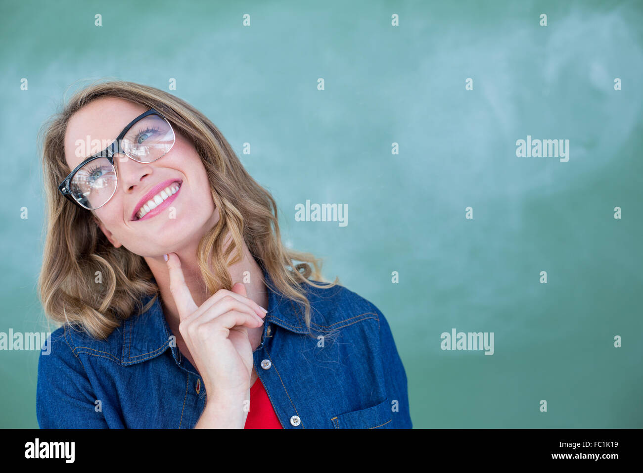 Smiling geeky teacher standing in front of blackboard Stock Photo - Alamy