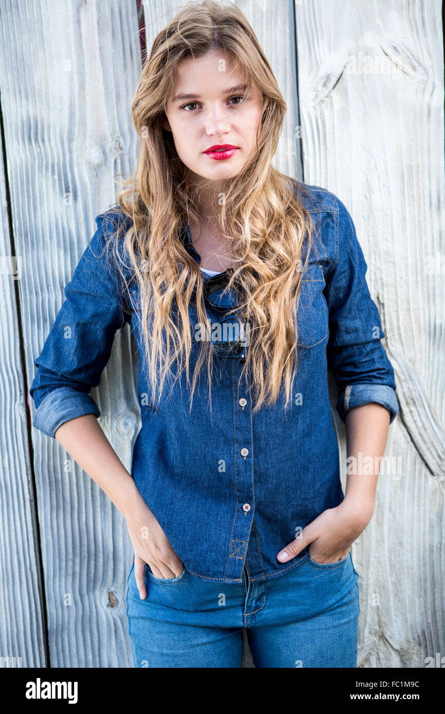 Pretty woman looking at camera with hands in pockets Stock Photo - Alamy