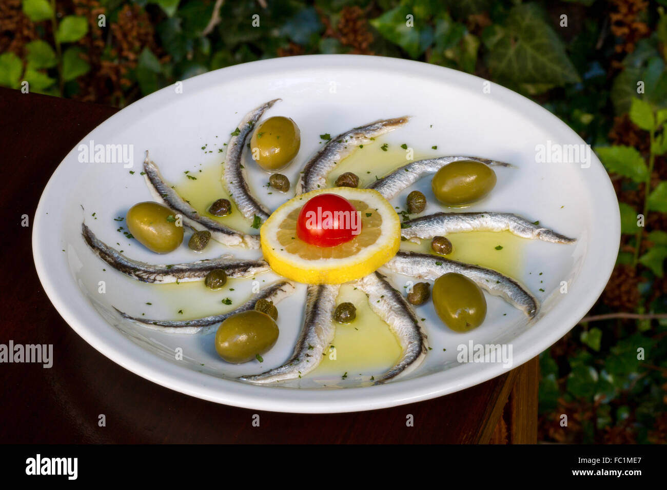 Marinated anchovies with green olives,capers and olive oil Stock Photo