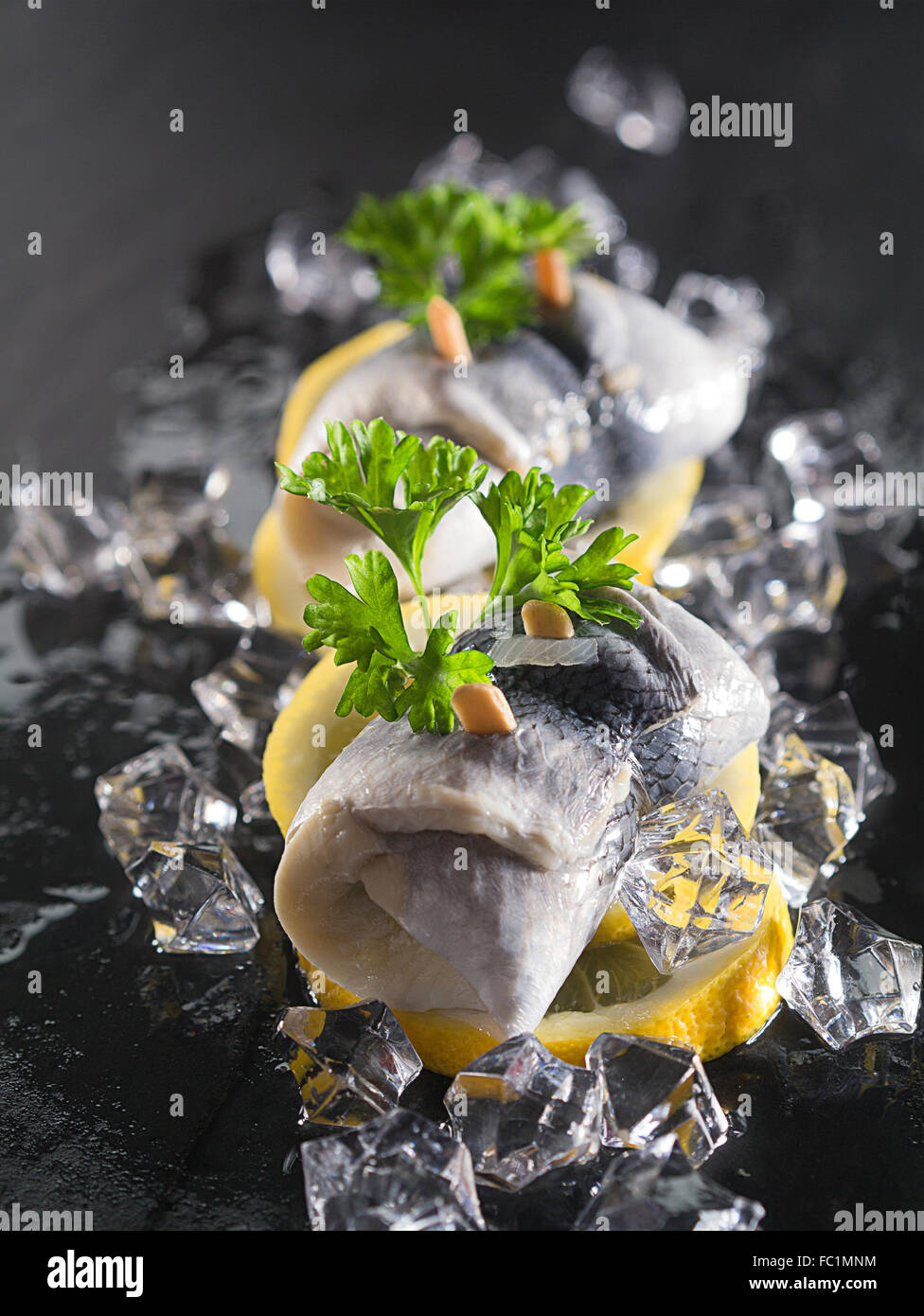 Rollmop herring on lemon slices Stock Photo