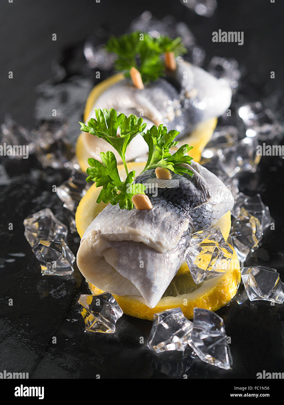 Rollmop herring on lemon slices Stock Photo