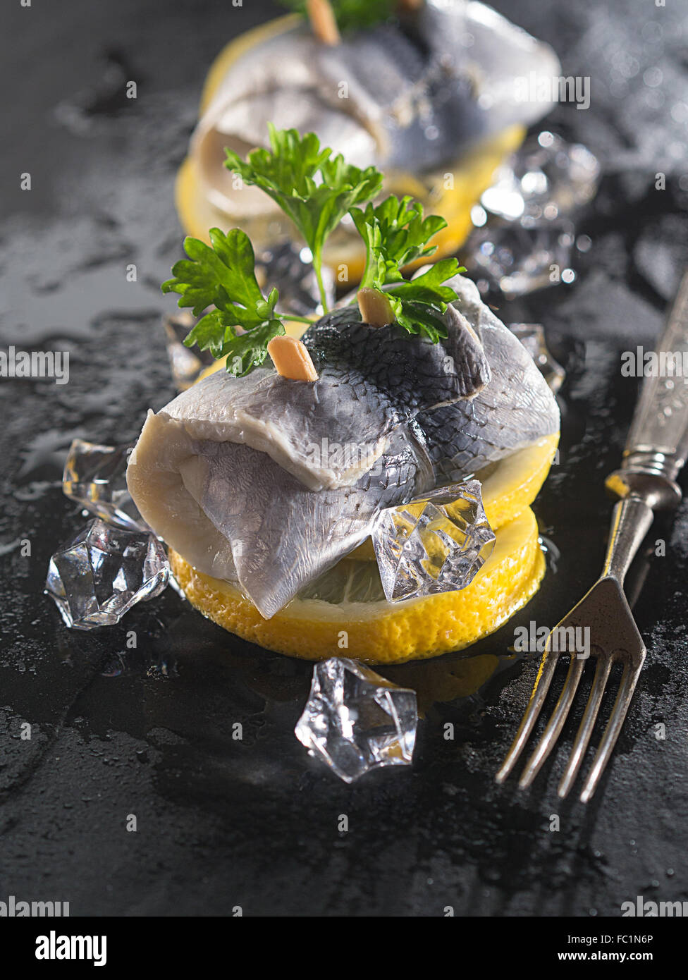 Rollmop herring on lemon slices Stock Photo