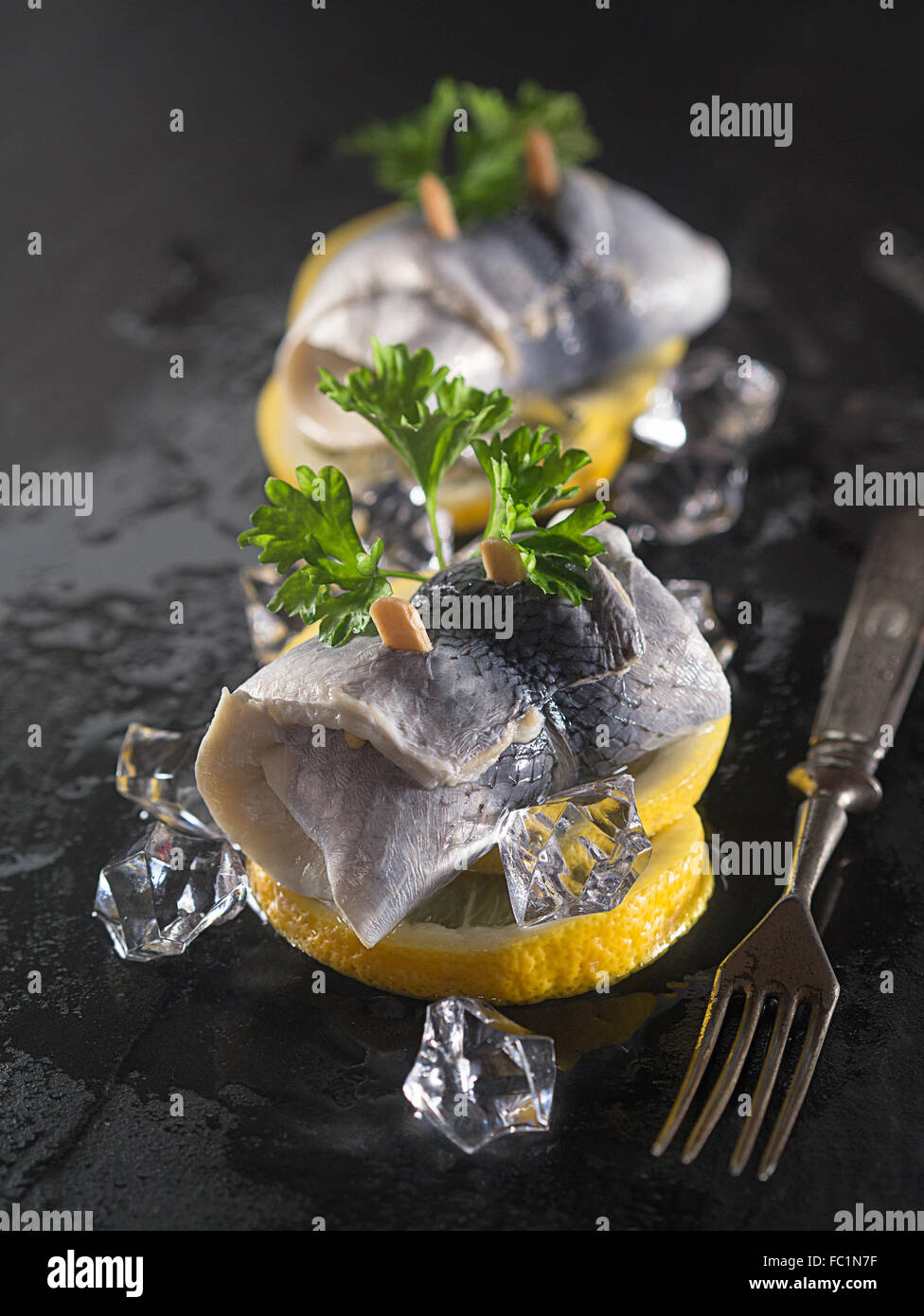 Rollmop herring on lemon slices Stock Photo