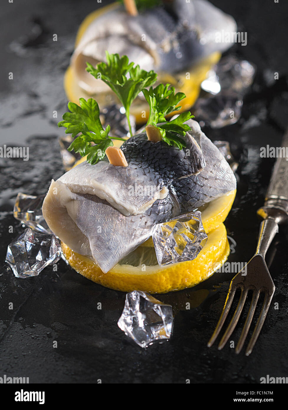 Rollmop herring on lemon slices Stock Photo