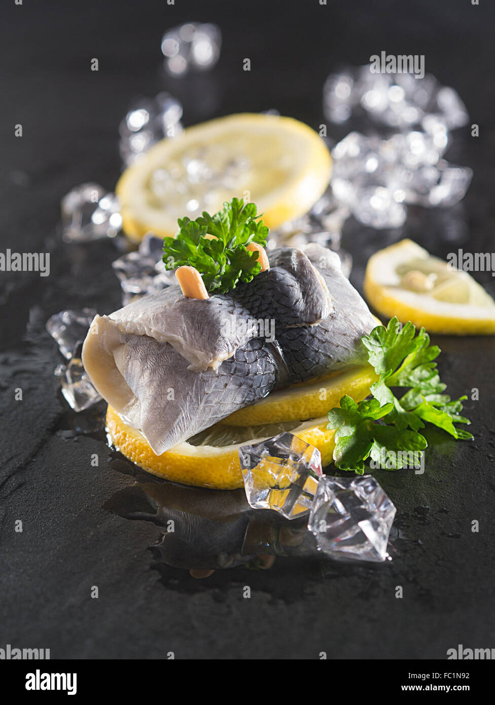 Rollmop herring on lemon slices Stock Photo