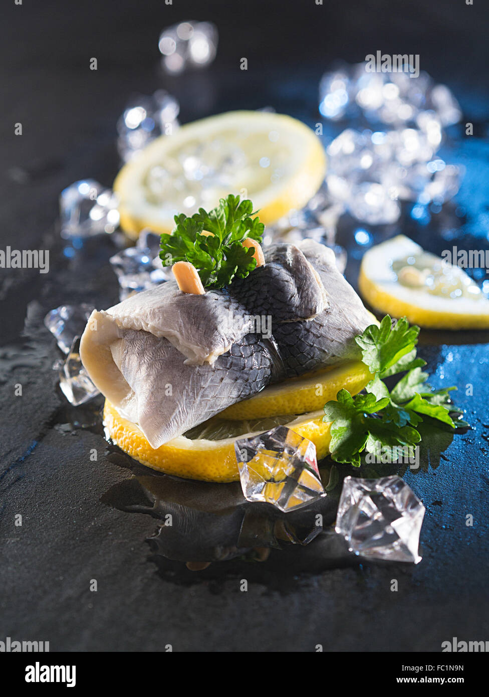 Rollmop herring on lemon slices Stock Photo