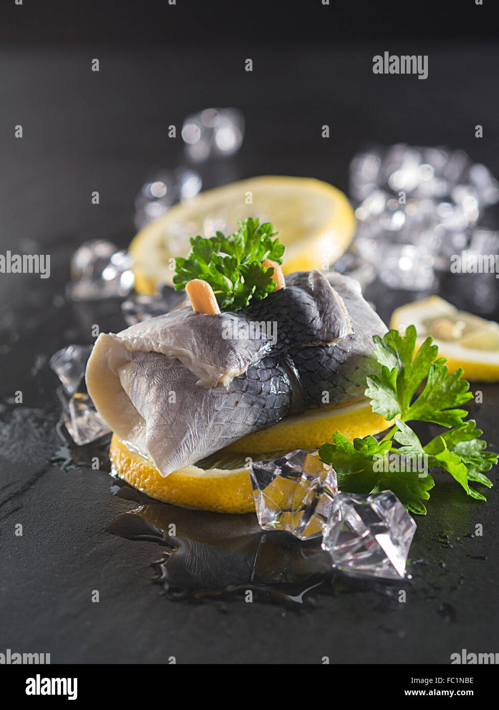 Rollmop herring on lemon slices Stock Photo