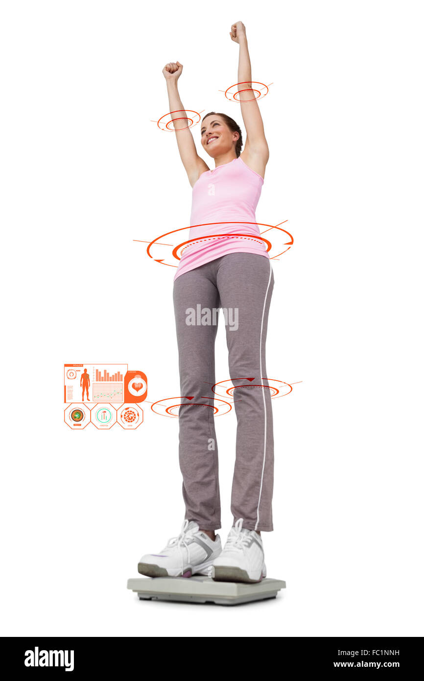 Composite image of young woman cheering on weight scale Stock Photo