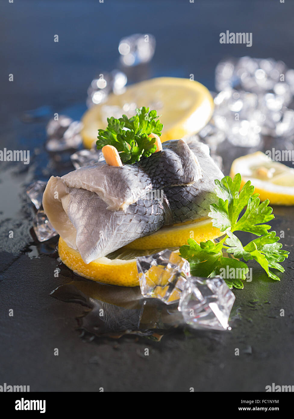 Rollmop herring on lemon slices Stock Photo