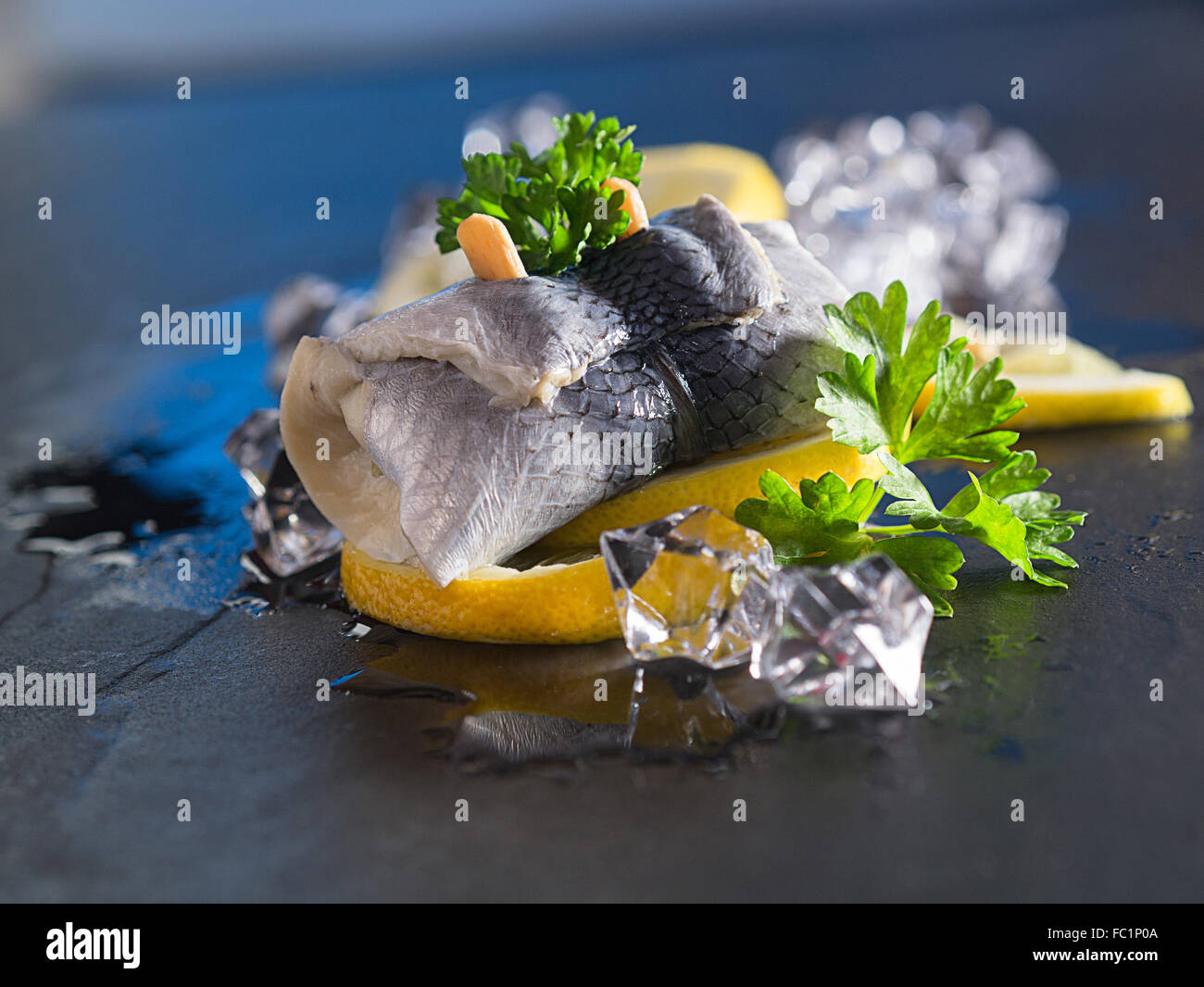 Rollmop herring on lemon slices Stock Photo