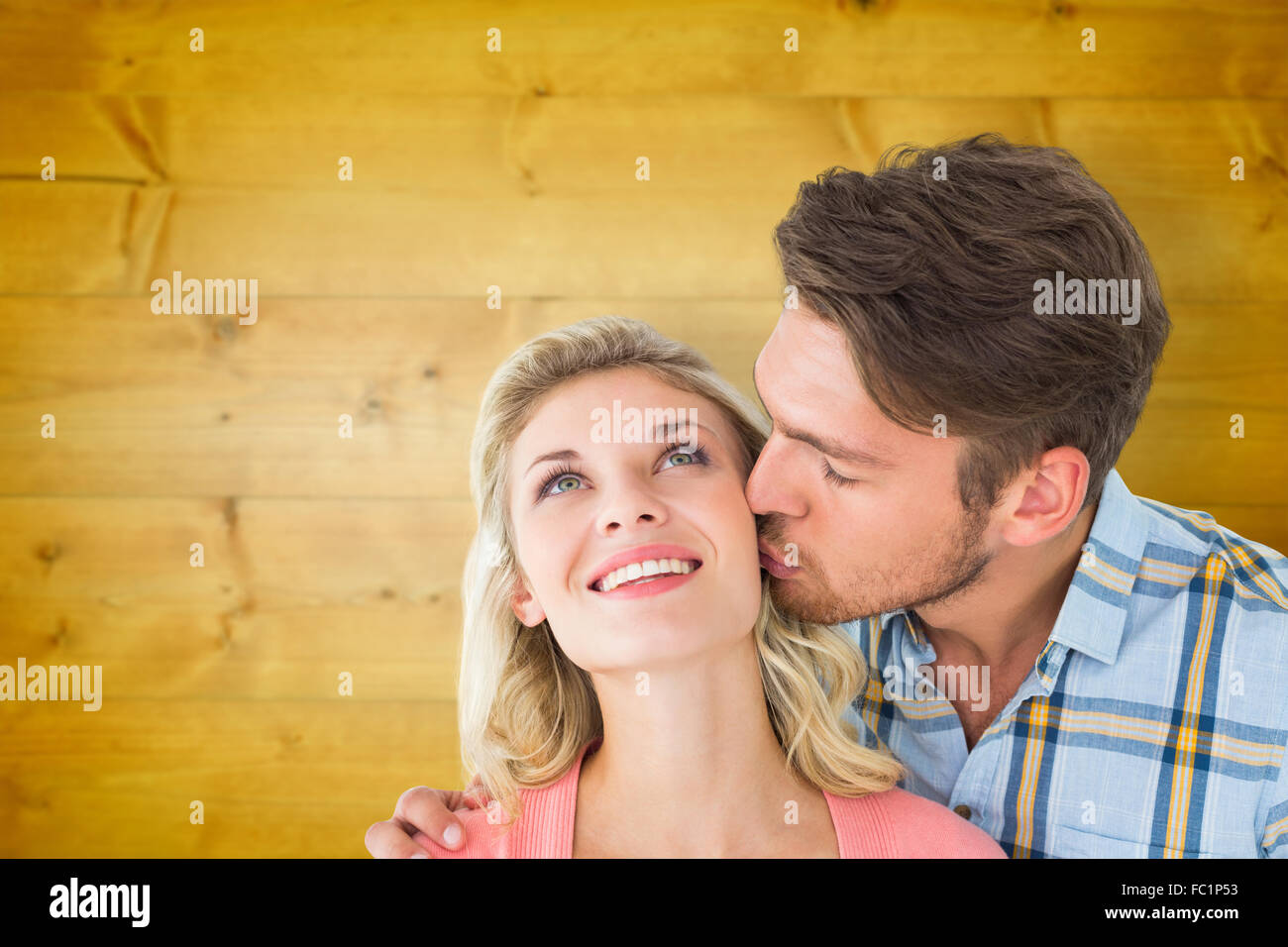 composite-image-of-handsome-man-kissing-girlfriend-on-cheek-stock-photo