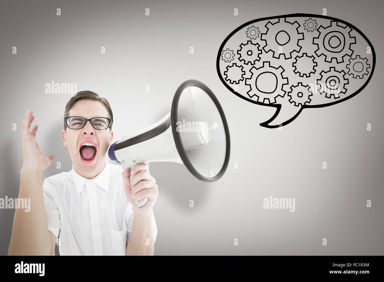 Composite image of geeky businessman shouting through megaphone Stock Photo