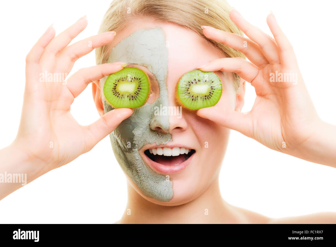 Skin care. Woman in clay mask with kiwi on face Stock Photo