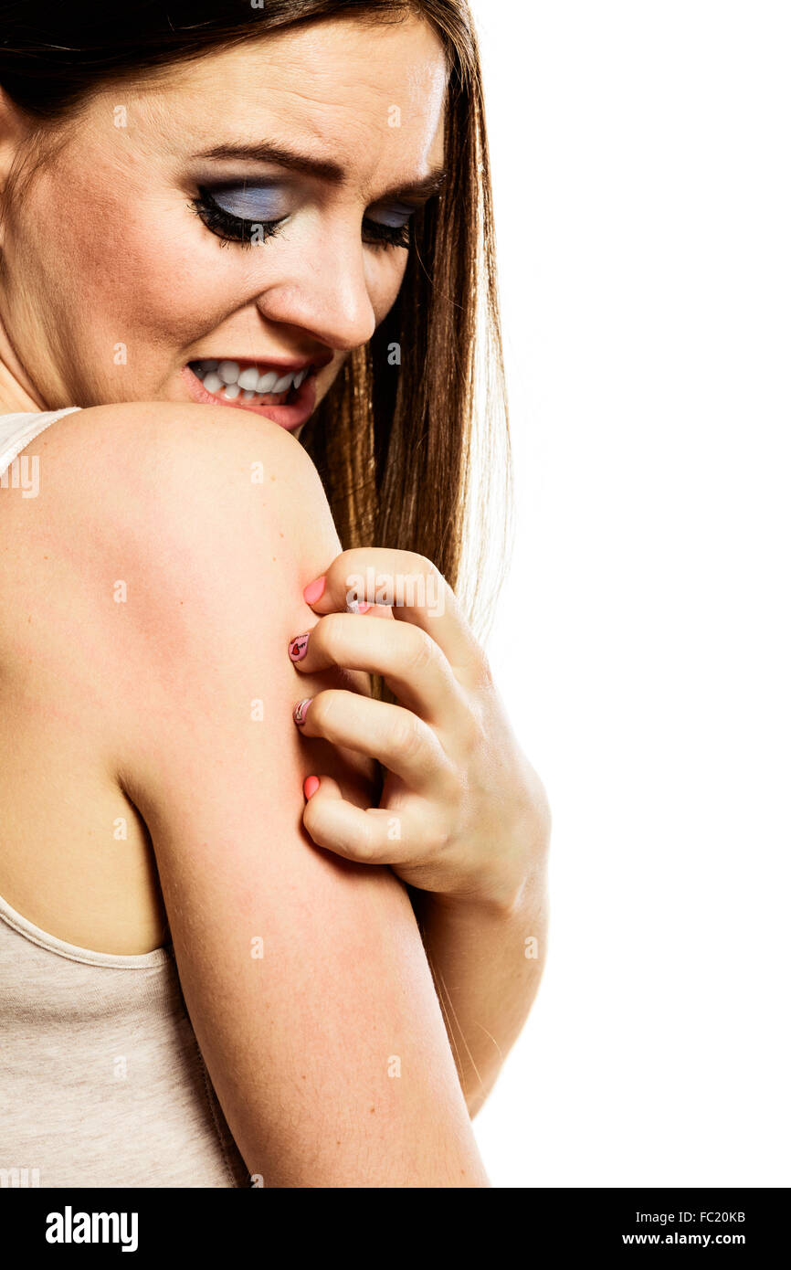 Woman scratching her arm Stock Photo