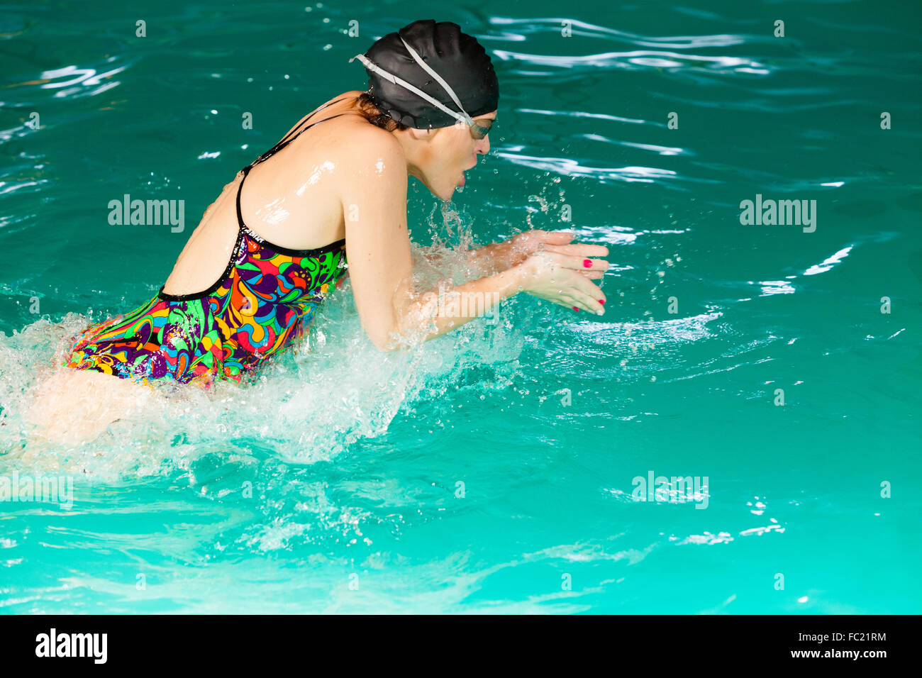 Swimming woman in pool. Stock Photo