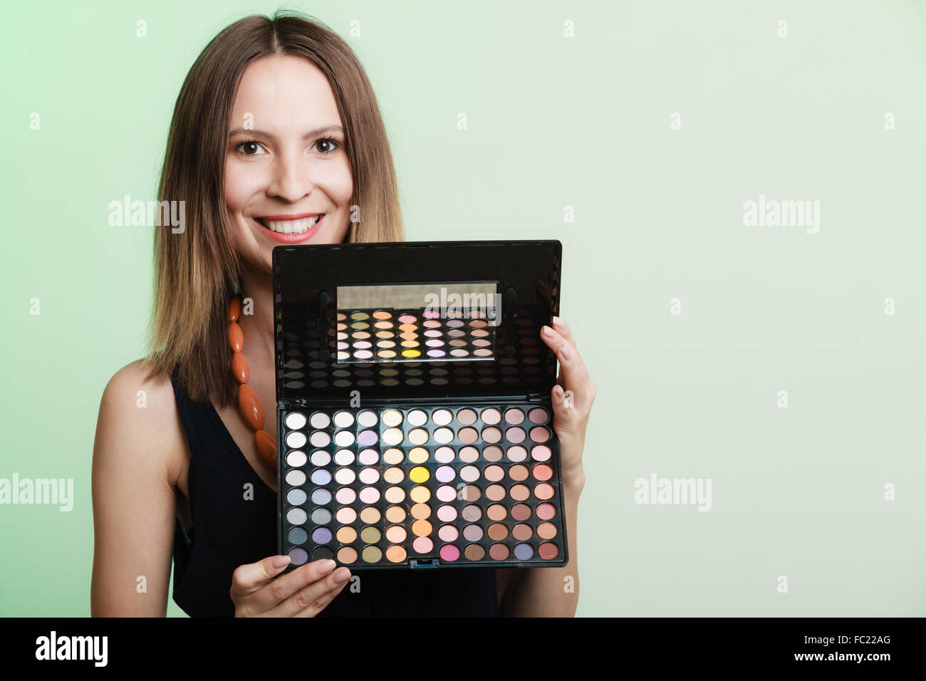 Woman holds makeup professional colorful palette Stock Photo