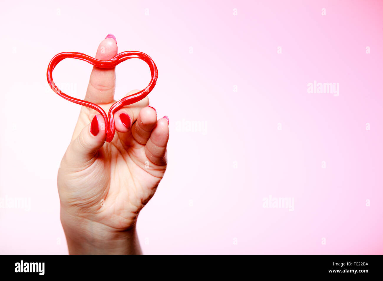 Female hahd holding red heart love symbol. Valentines day. Stock Photo