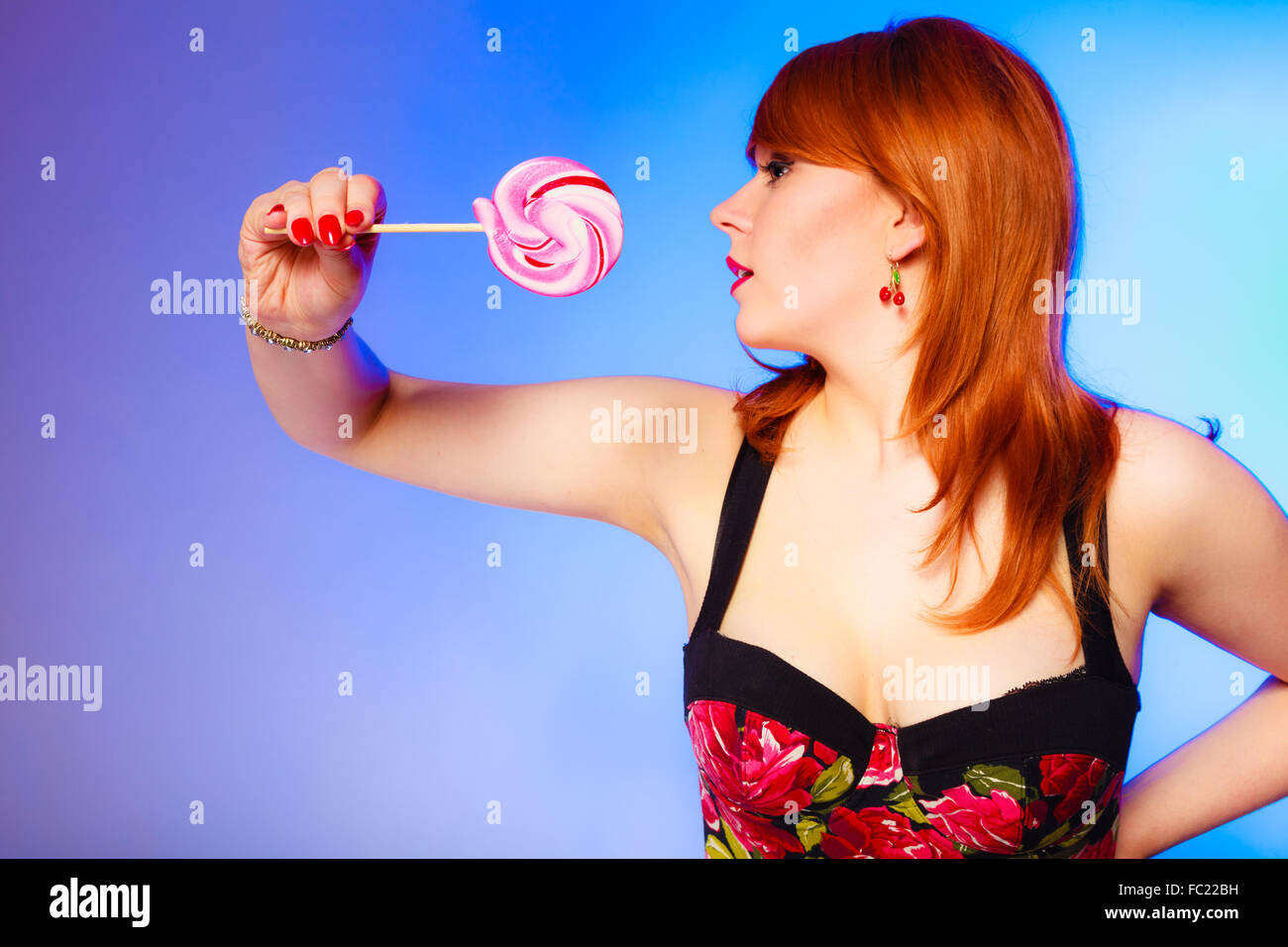 Woman with sweet candy lollipop in hand. Stock Photo