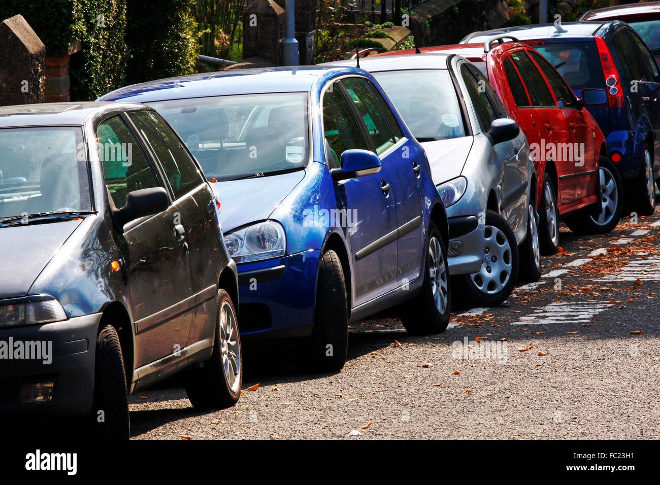 Cars tightly parked in an urban street Stock Photo