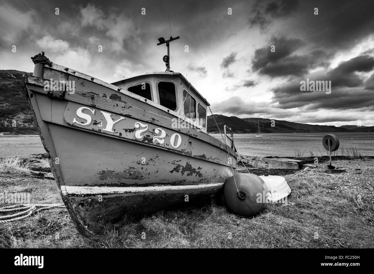 A boat on the beach at Invershiel, on the banks of Loch Duich in the Scottish Highlands, UK Stock Photo