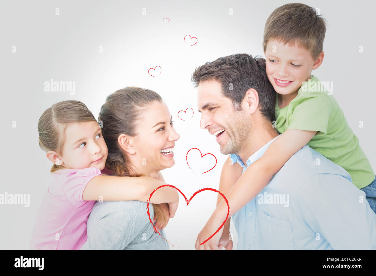 Composite image of cheerful young family posing Stock Photo